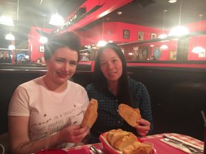 Visitor Daisy C. from Manchester, England and Greeter Diane enjoy a shared love of garlic bread (Saucy Noodle, Denver)